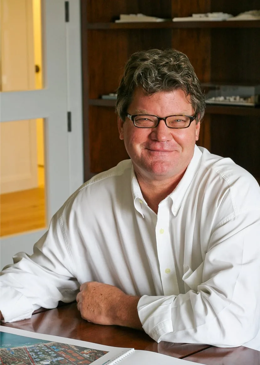 Doug Kulig at his desk, a site plan open in front of him