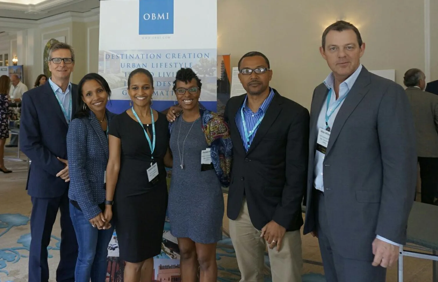 The OBMI team at a conference stand, Marvin Flax among them