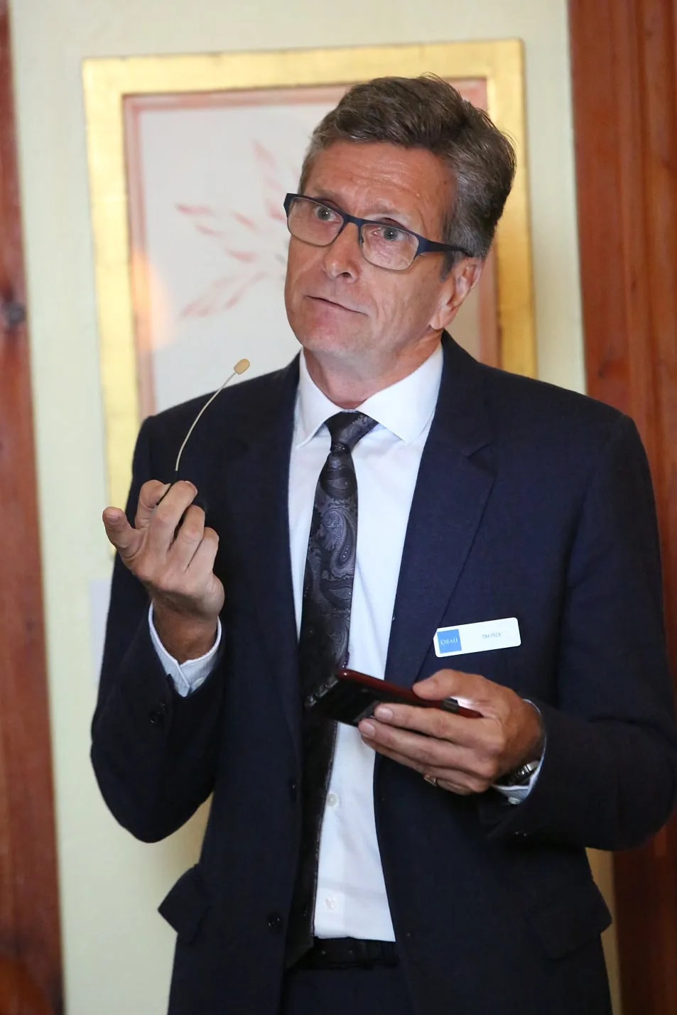 Tim Peck speaking at the anniversary party, a microphone in his hand