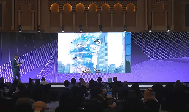 The award ceremony stage, Aera projected on the screen above the audience