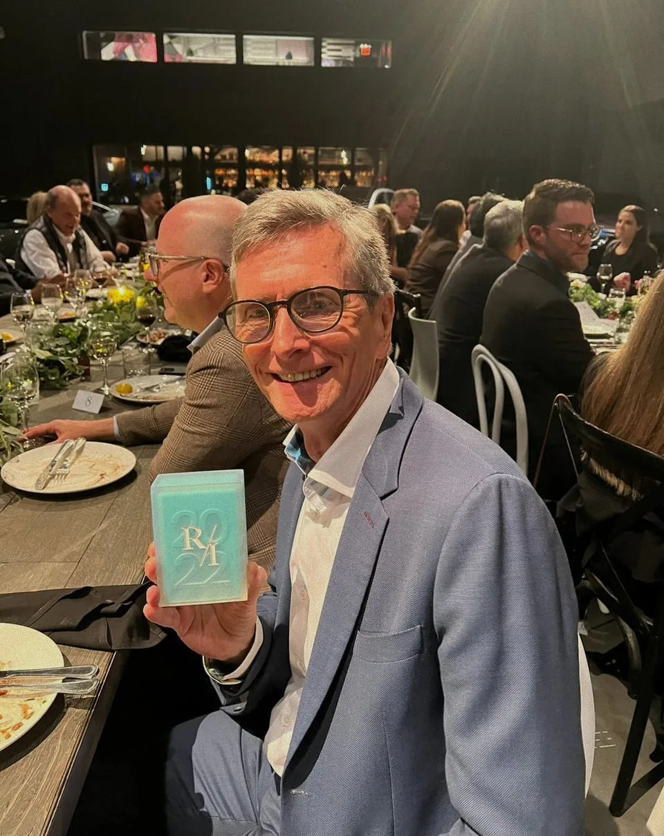 Tim Peck at the awards dinner, holding up the Radical Innovation Award