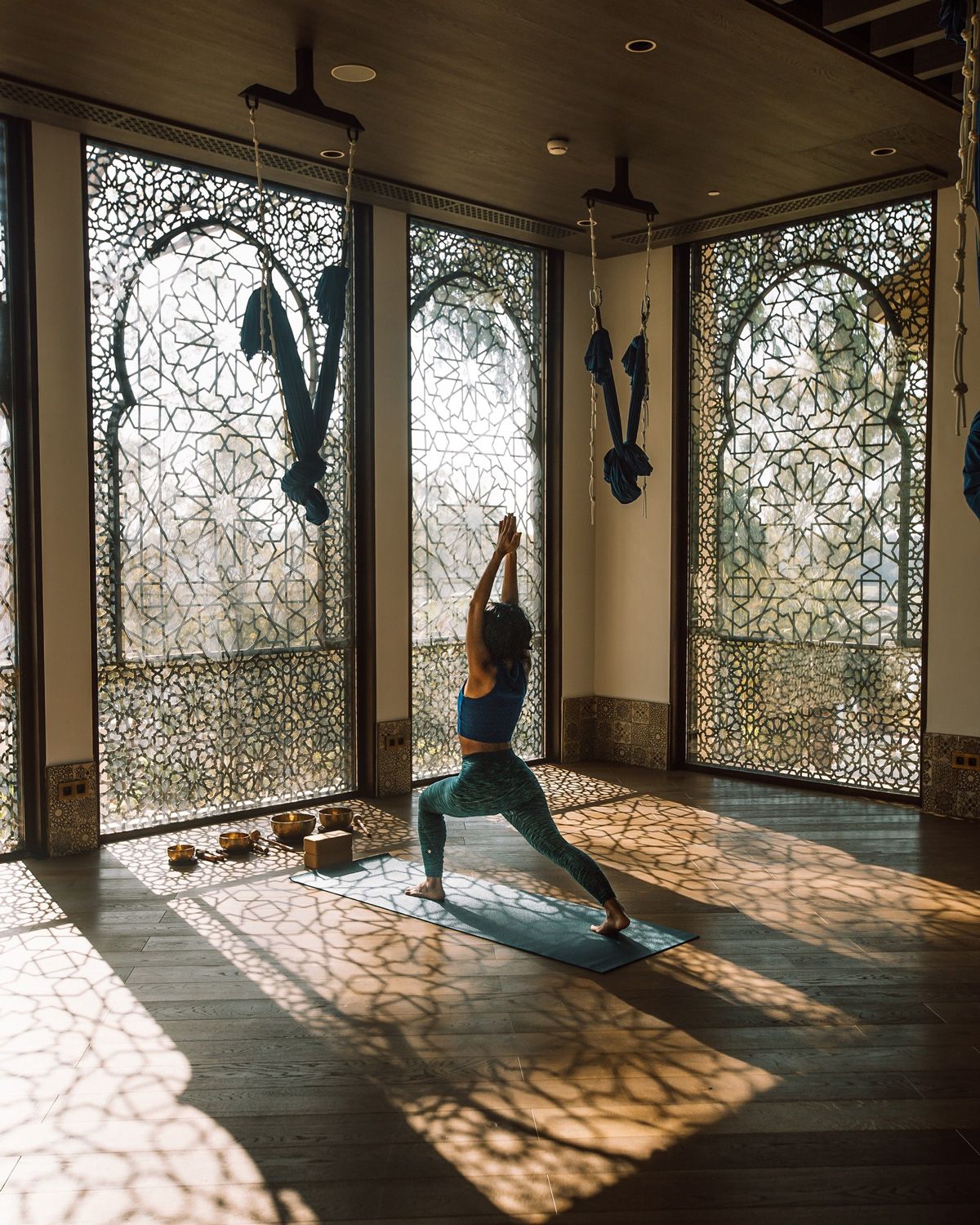 A woman practicing yoga at Tazi Palace