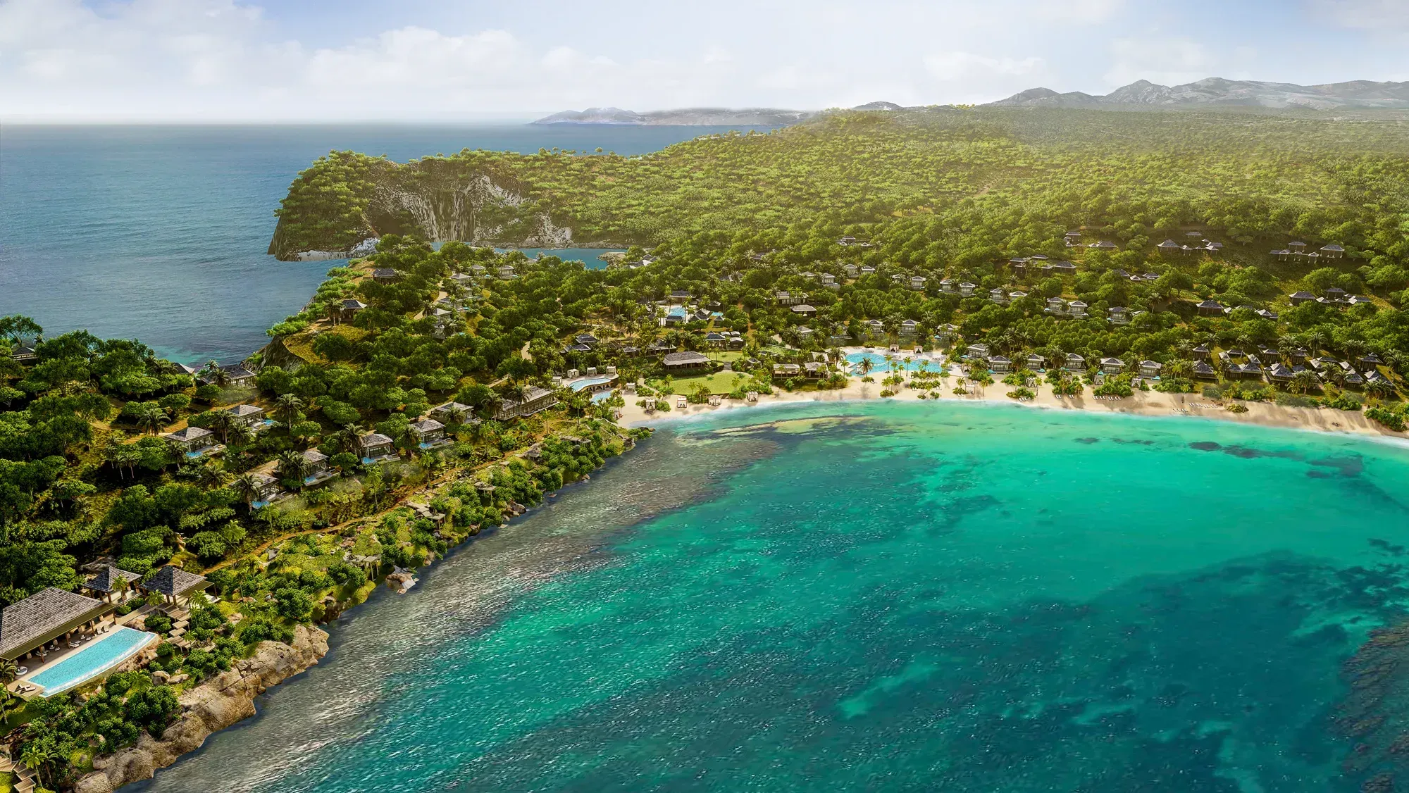 The resort from the air: villas along the headland, the beach and the bay