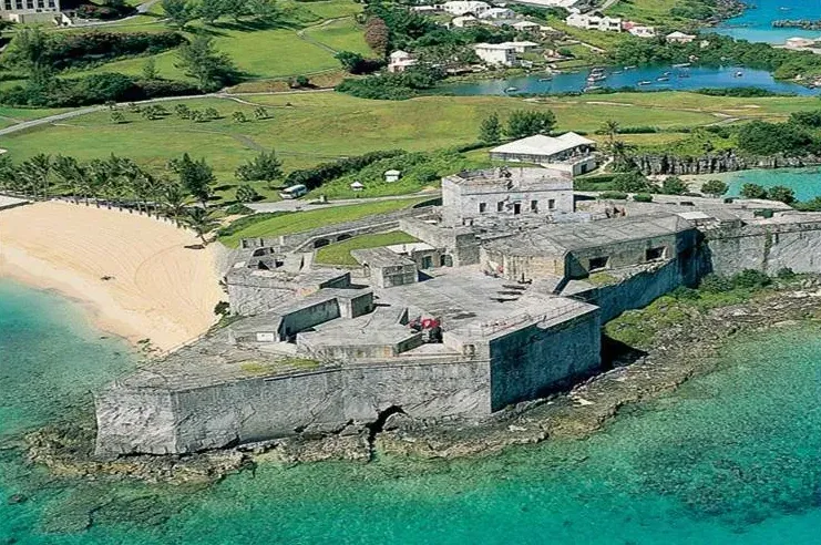 Fort St Catherine from the air, its bastions on the rock above the pink beach