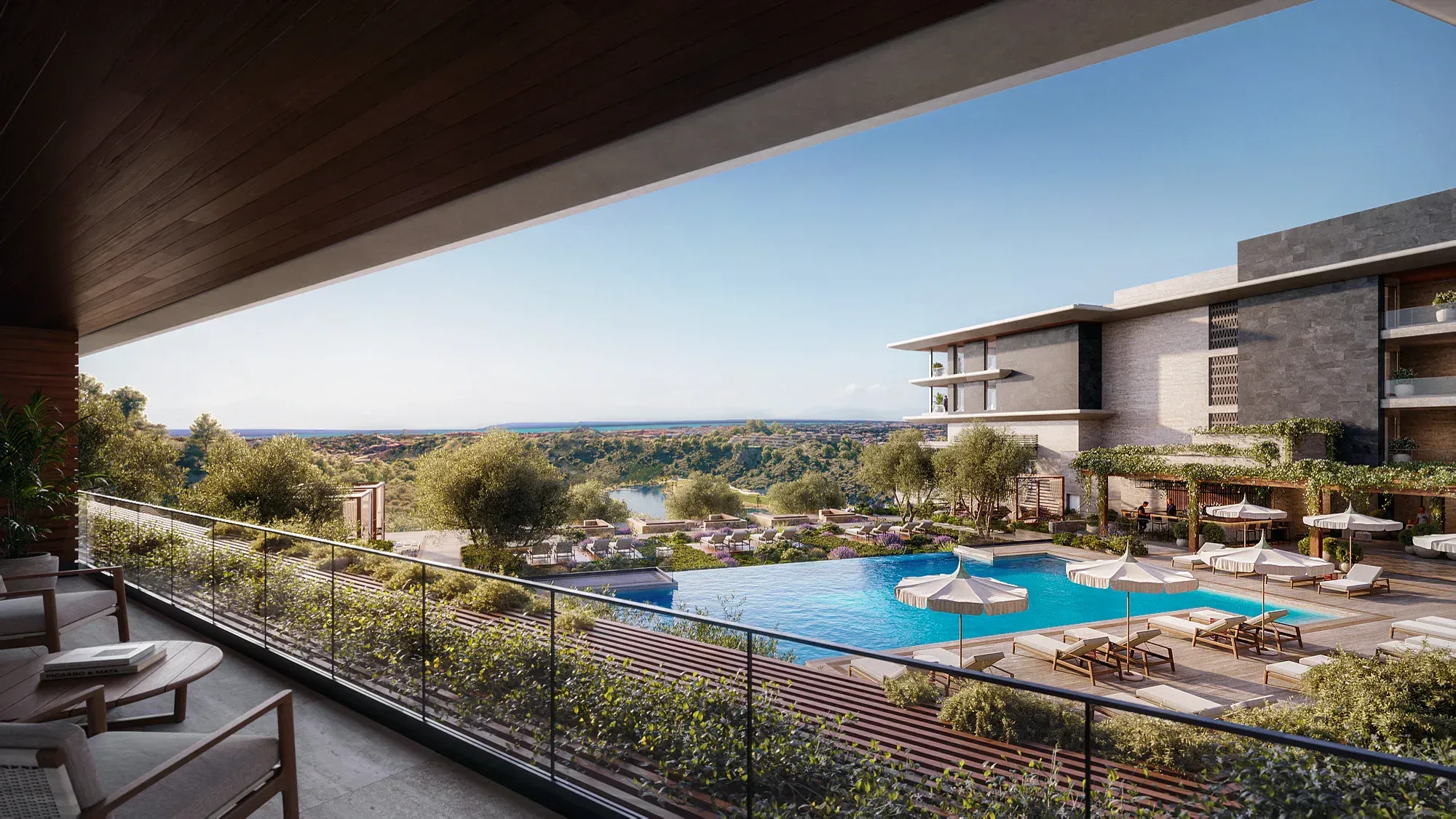 From a balcony: the pool terrace, the hillside and the sea on the horizon