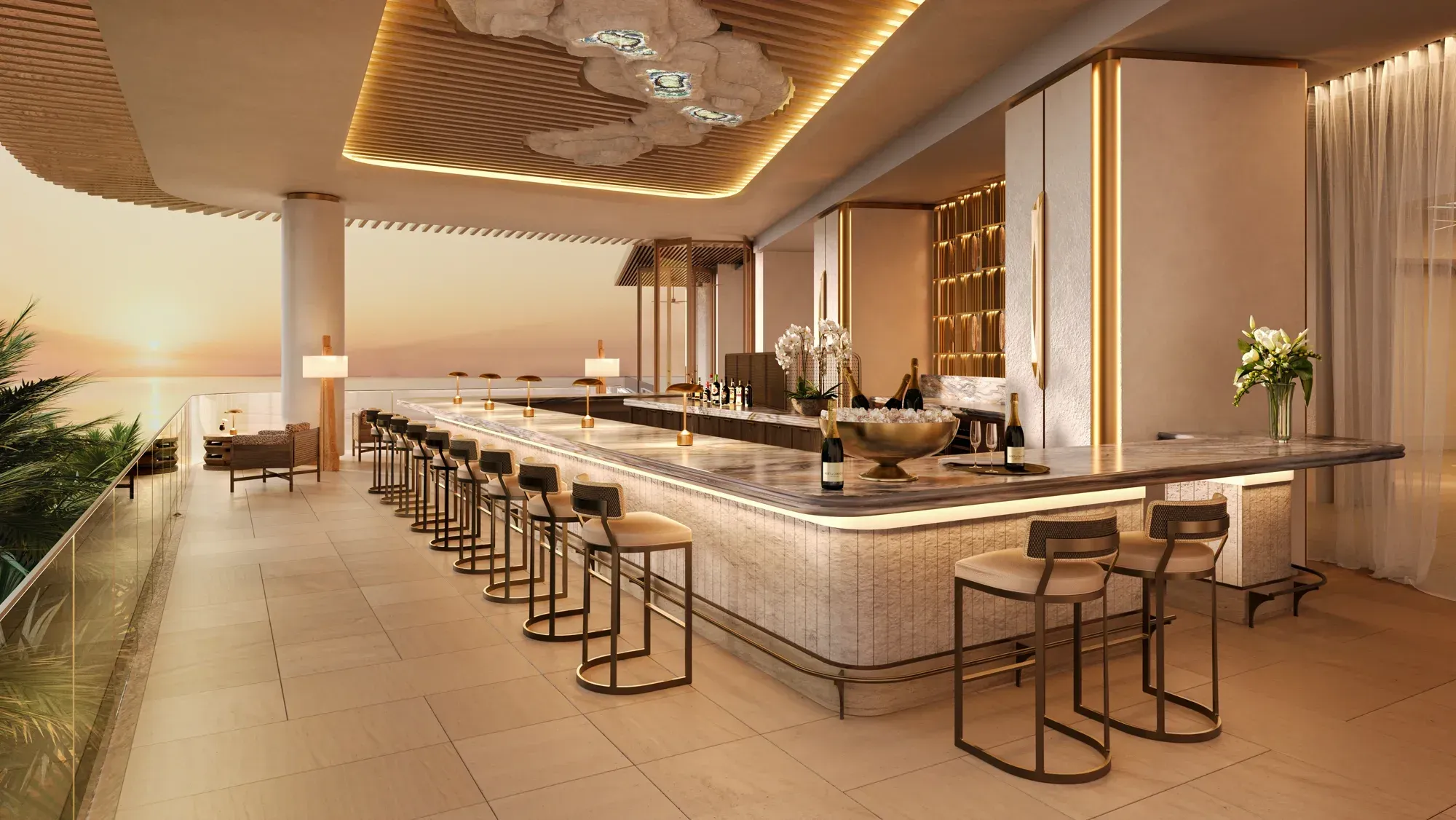 A long bar at sunset, brass stools along it, the sea beyond the terrace
