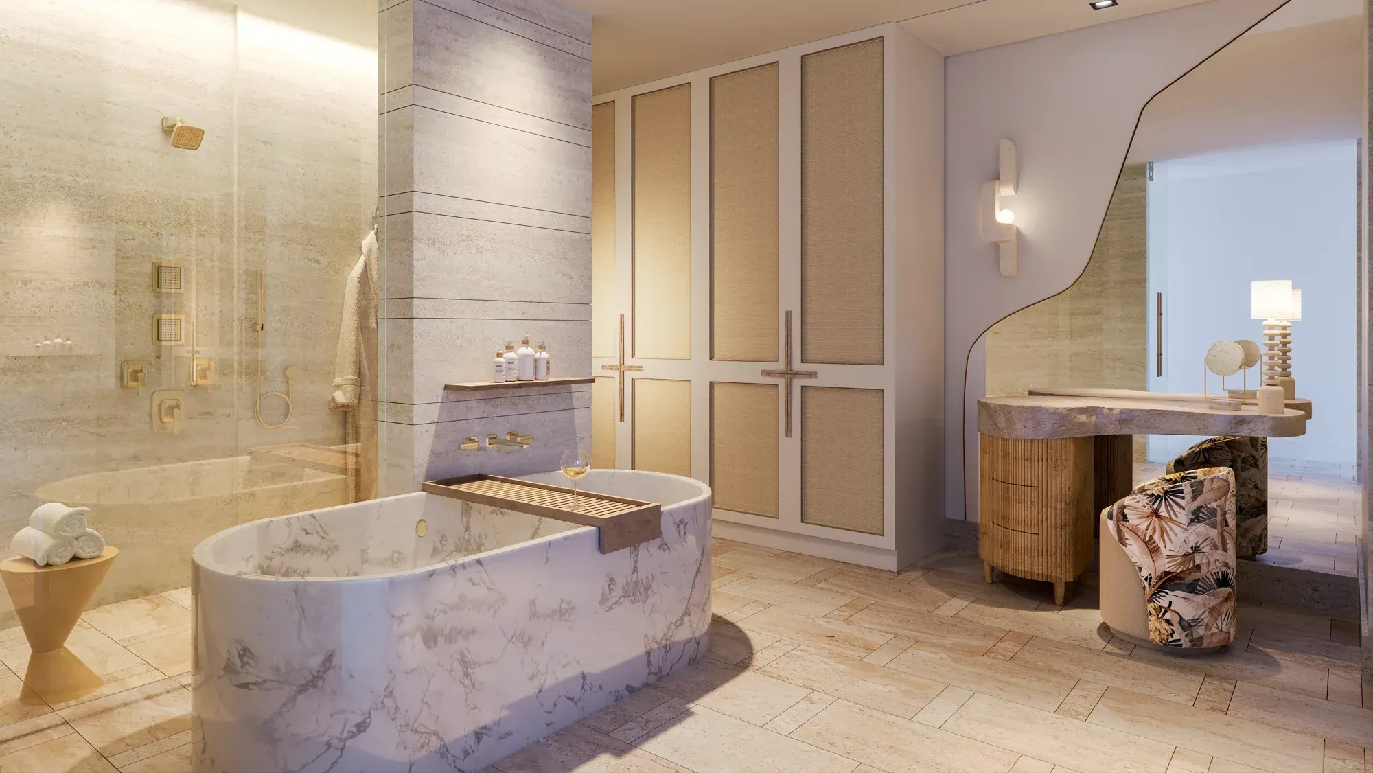 A bathroom: a marble tub, travertine walls and a curved vanity