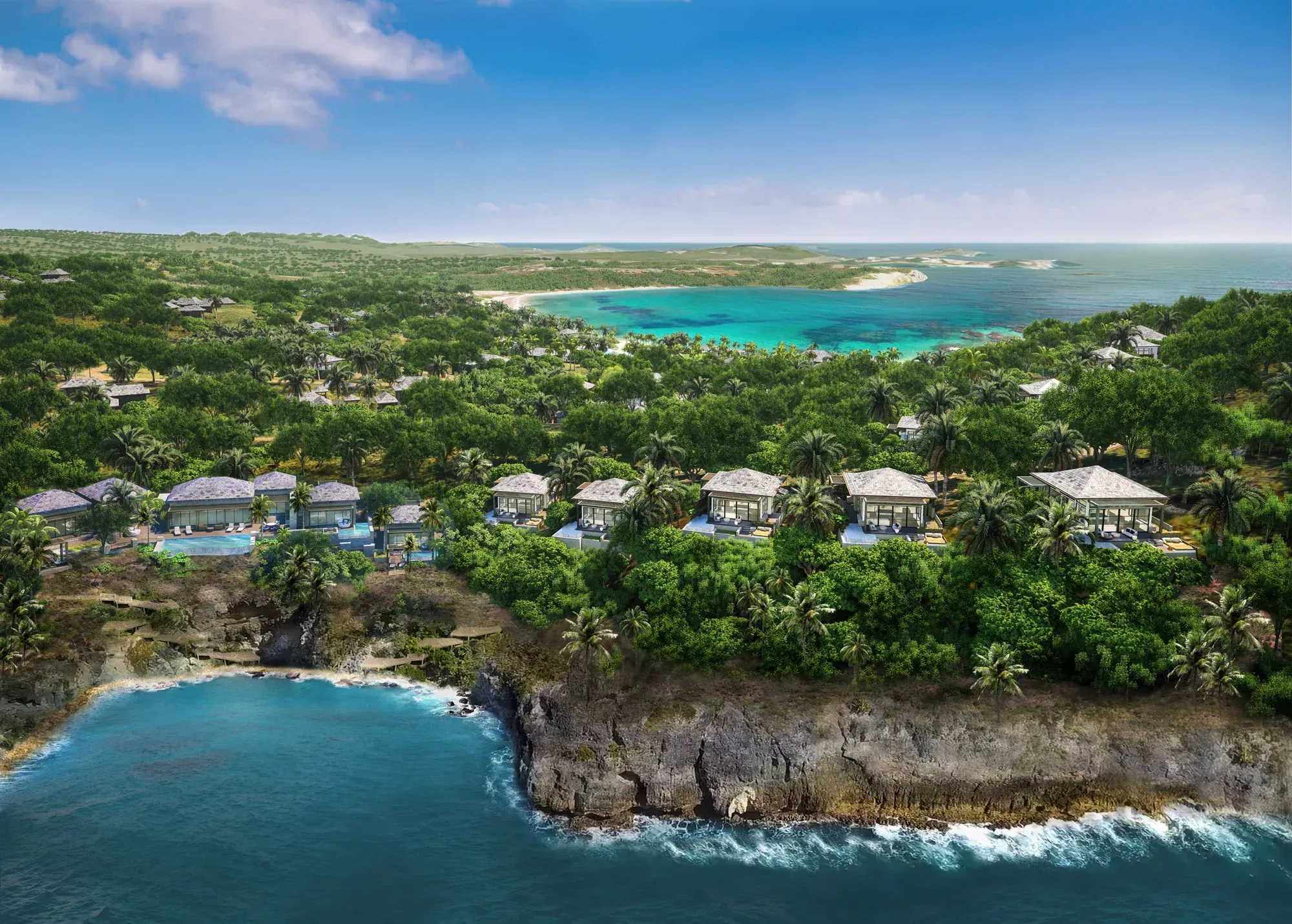 Villas on a cliff over dark rock and surf, the bay beyond