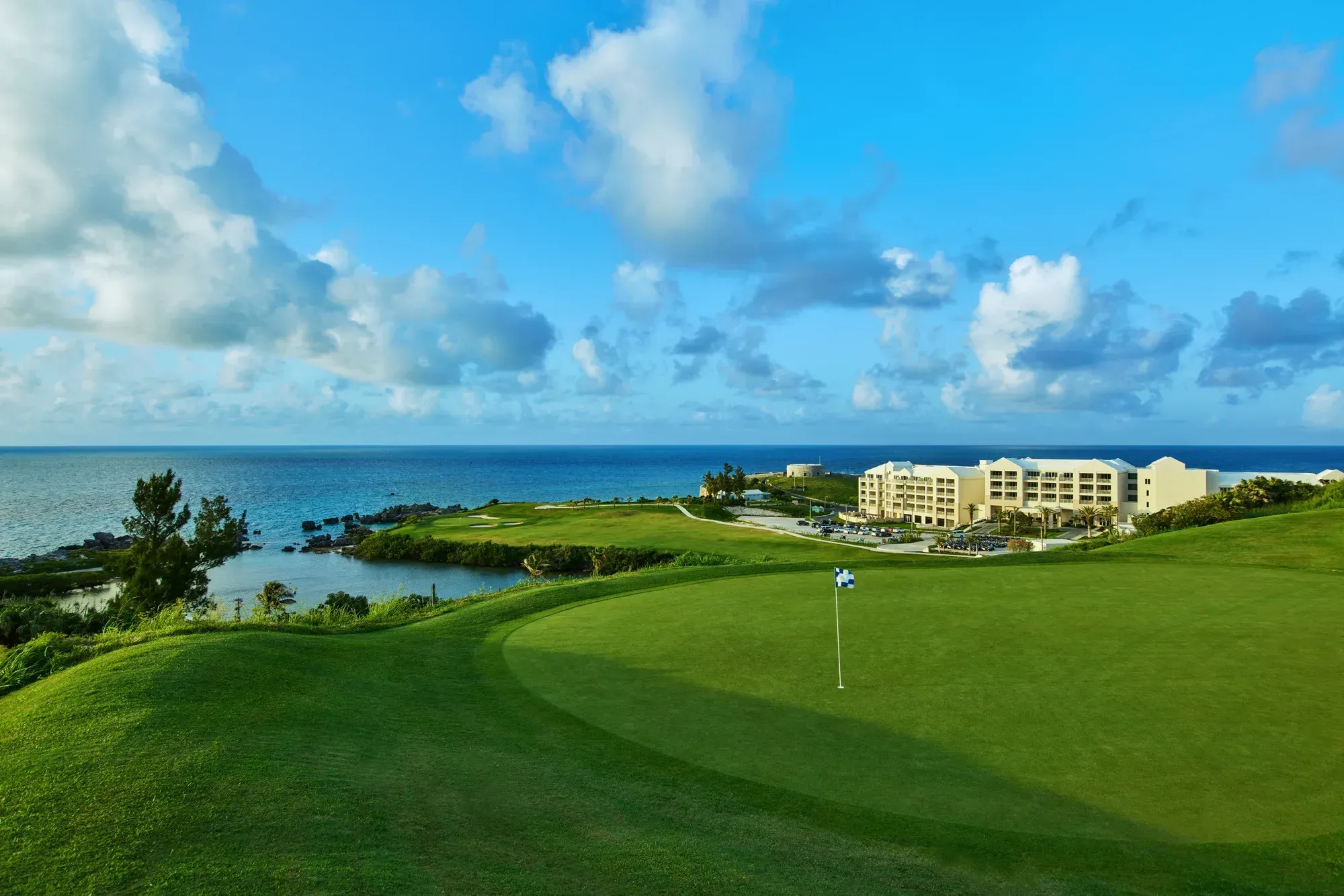 A green on the golf course, the hotel and Fort St Catherine on the shore beyond
