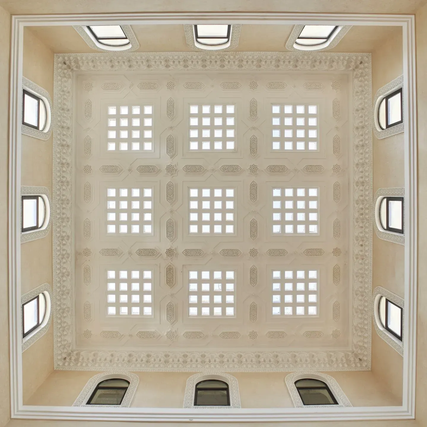 The foyer ceiling from below: nine honeycomb skylights in carved plaster
