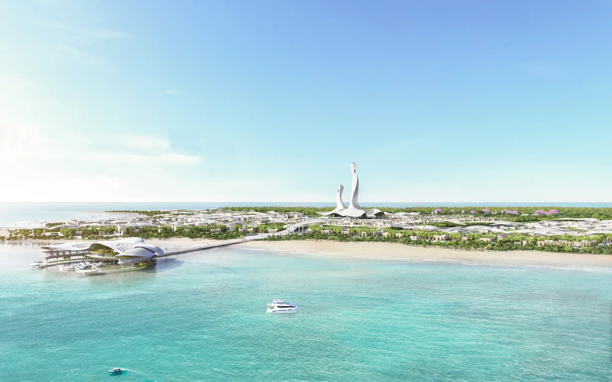 The island from the sea: a long beach, low buildings among trees, the towers rising at the centre