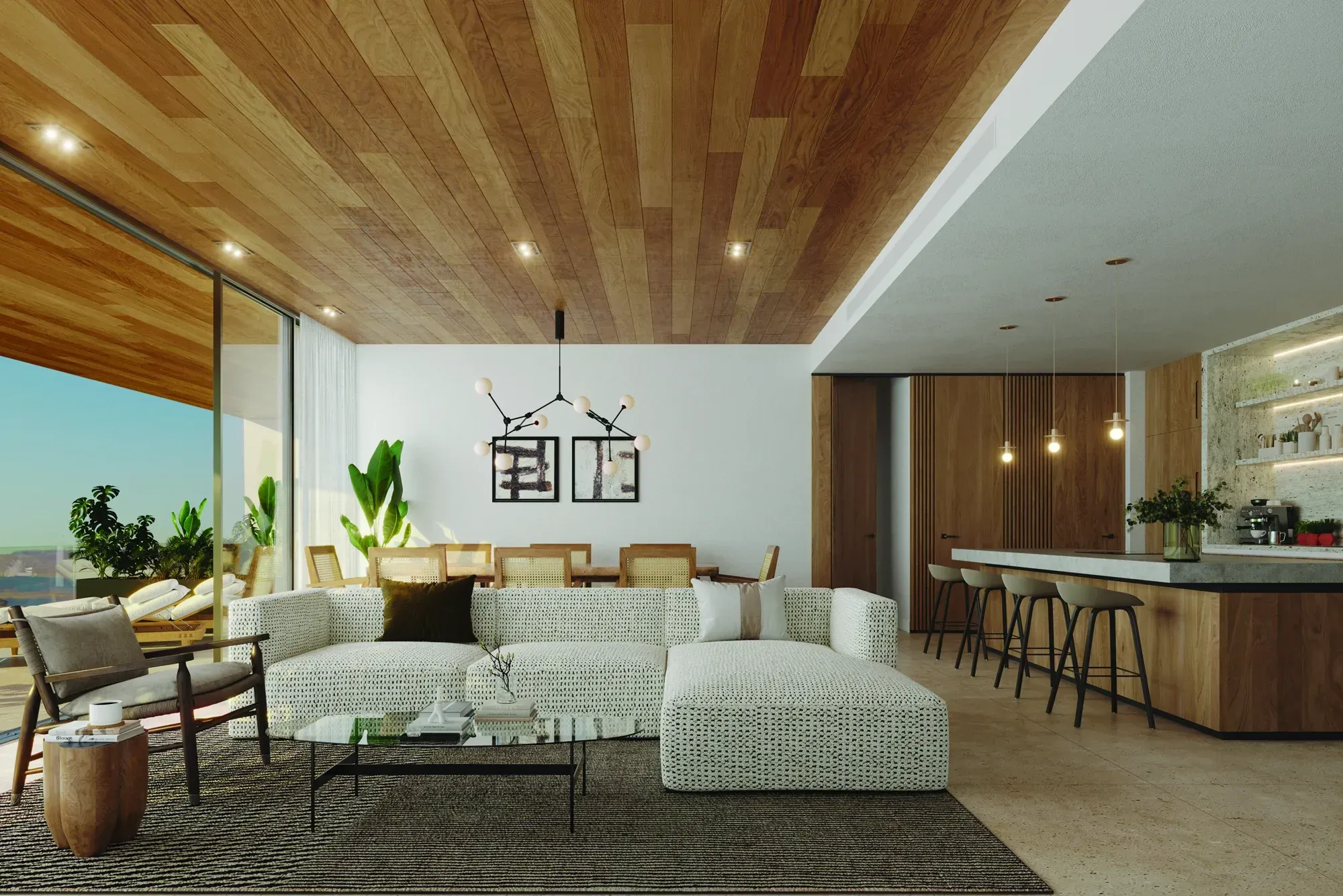 A residence living room under a timber ceiling, open to a terrace, the kitchen behind
