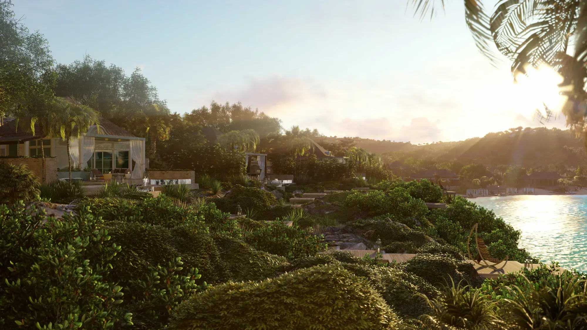 Villas among the vegetation at sunset, the bay lit below